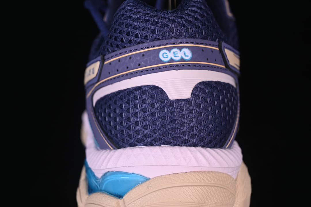 Rear view of the sneaker showing mesh panels and layered heel detailing.