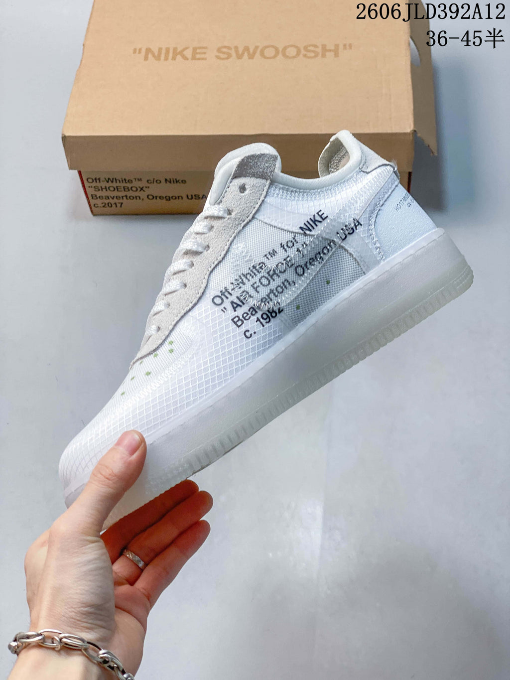 Side view showing printed text, a white upper, and light gray overlays
