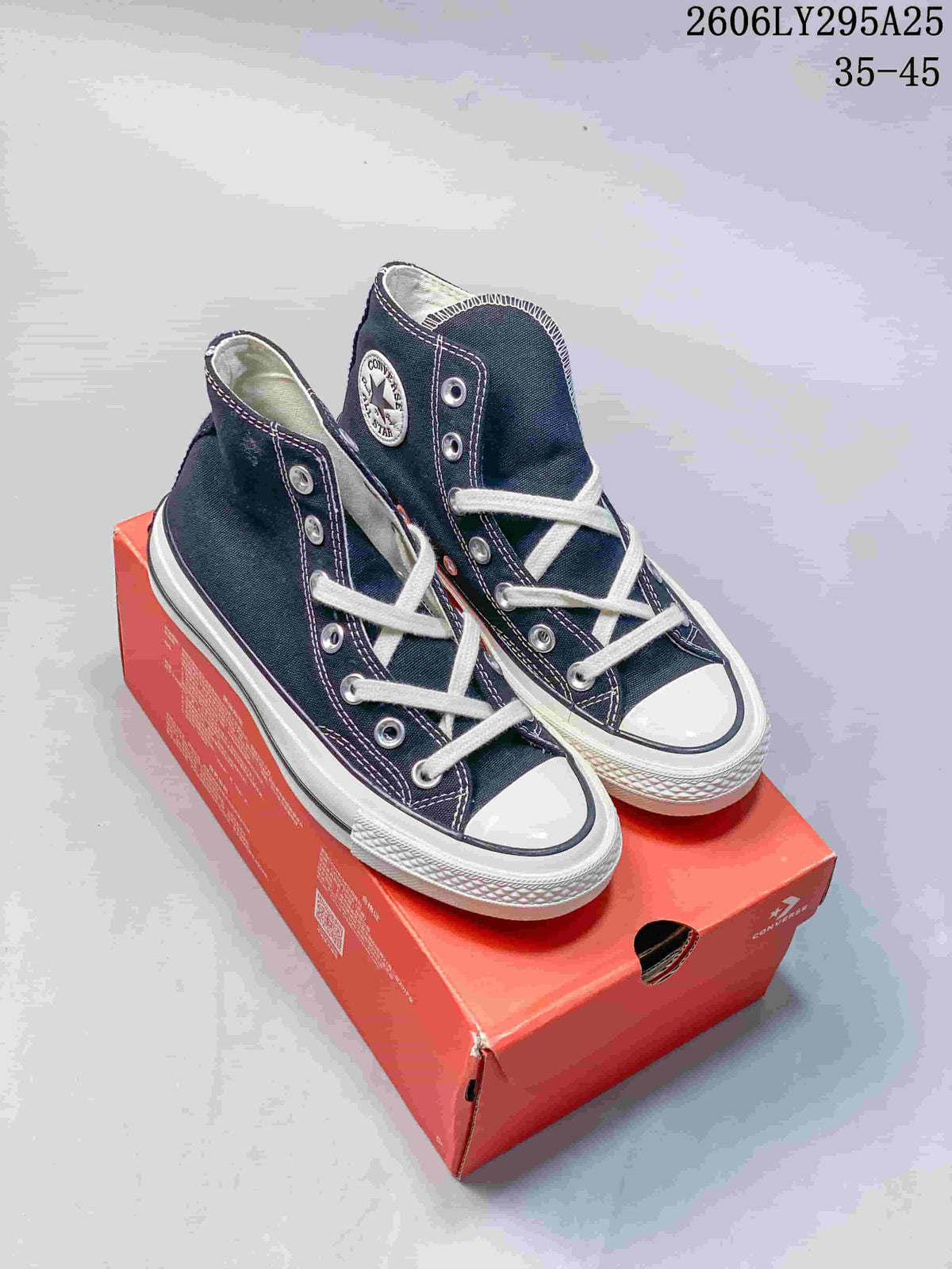 Pair of navy Converse Chuck Taylor All Star high-top sneakers with white laces and rubber soles