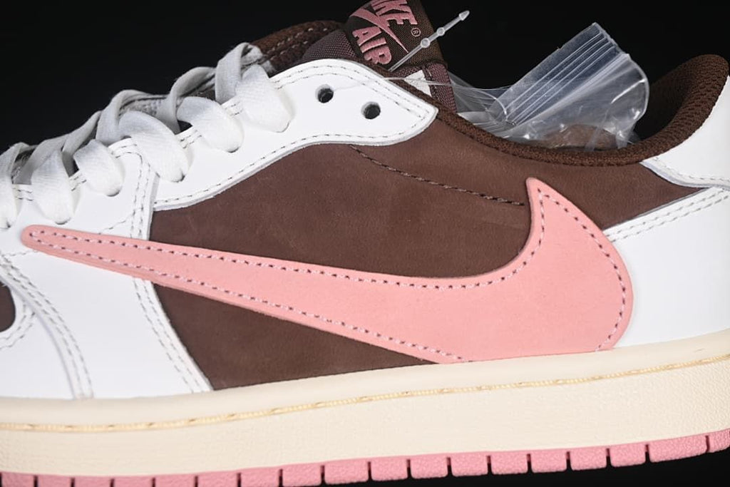 Close-up of the pink side Swoosh, brown panel, white overlays, and cream-colored midsole.
