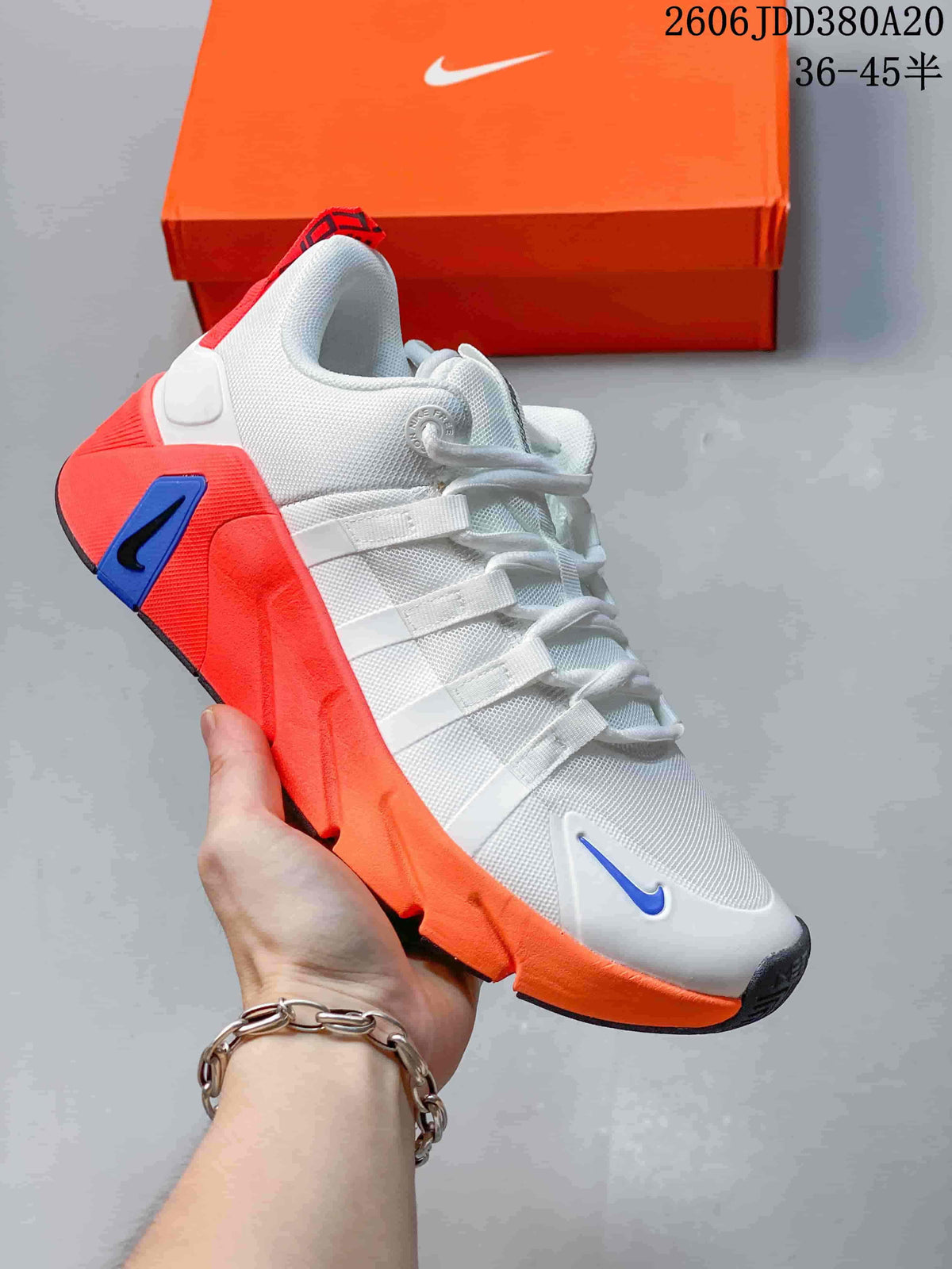White Nike Free Metcon 7 shoe with bright orange-red and blue accents