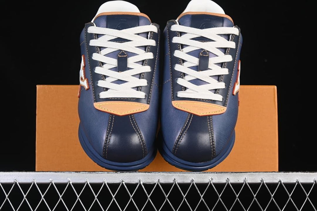 Front view of the pair showing white laces and tan toe accents