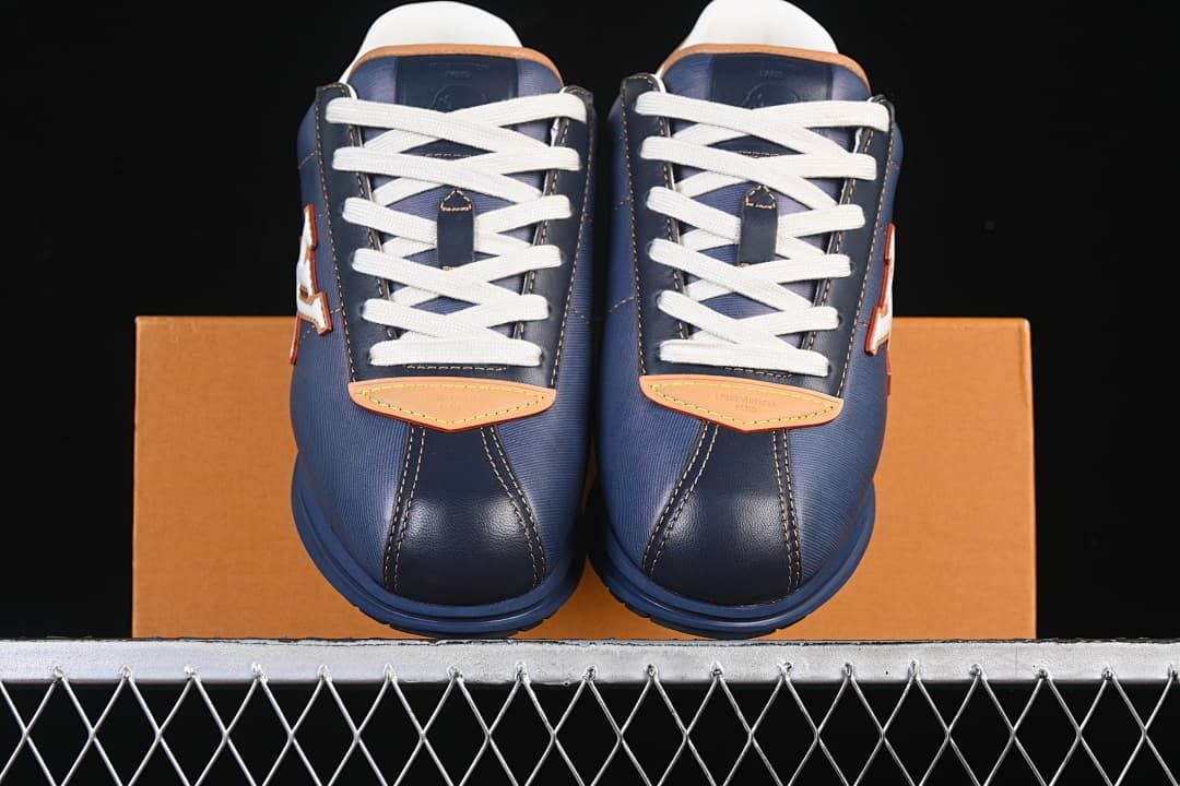 Front view of the pair showing white laces and tan toe accents