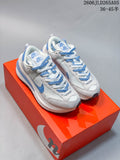 Pair of light-colored Nike Sacai LDWaffle sneakers with blue accents, shown from above