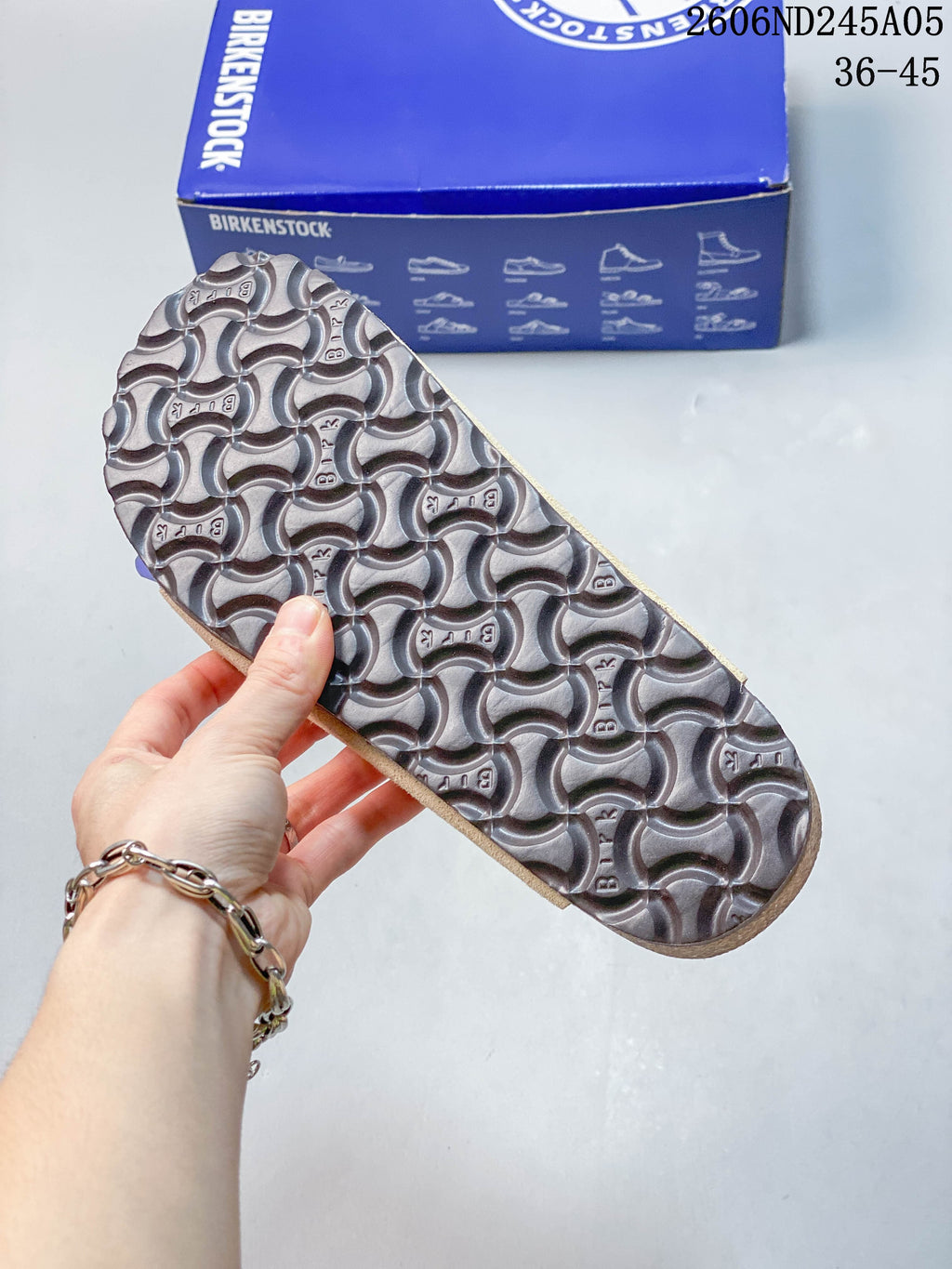 Close-up of the sandal outsole with a repeating textured tread pattern.