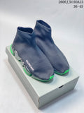 Navy Balenciaga sock-style sneakers with segmented translucent soles and neon-green accents