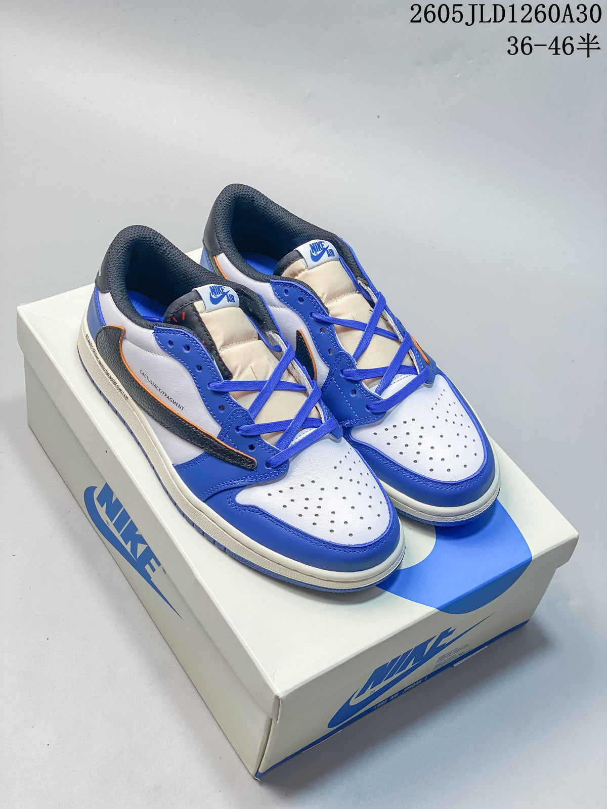 Pair of blue, white, and dark-accent low-top sneakers on a shoebox