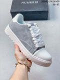 Gray-and-white Numeris low-top lace-up sneaker with a chunky treaded sole.