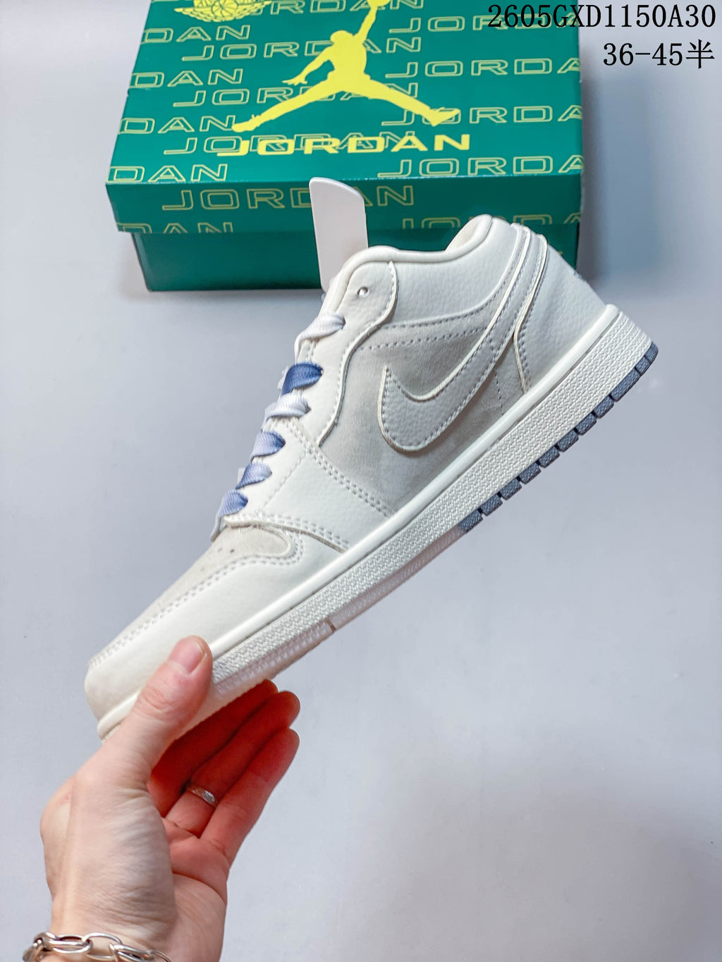 Side profile showing the low-top silhouette, light gray panels, and side logo.