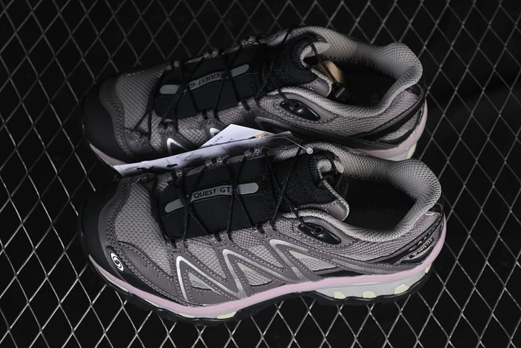 Pair of grey and black Salomon trail shoes shown from above