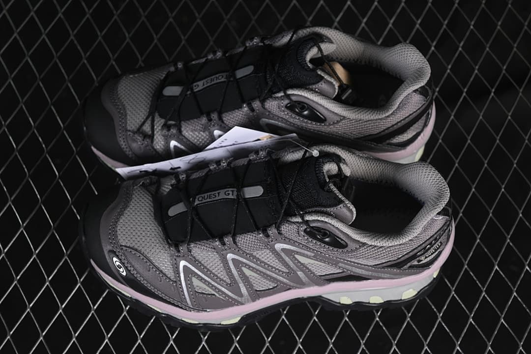 Pair of grey and black Salomon trail shoes shown from above