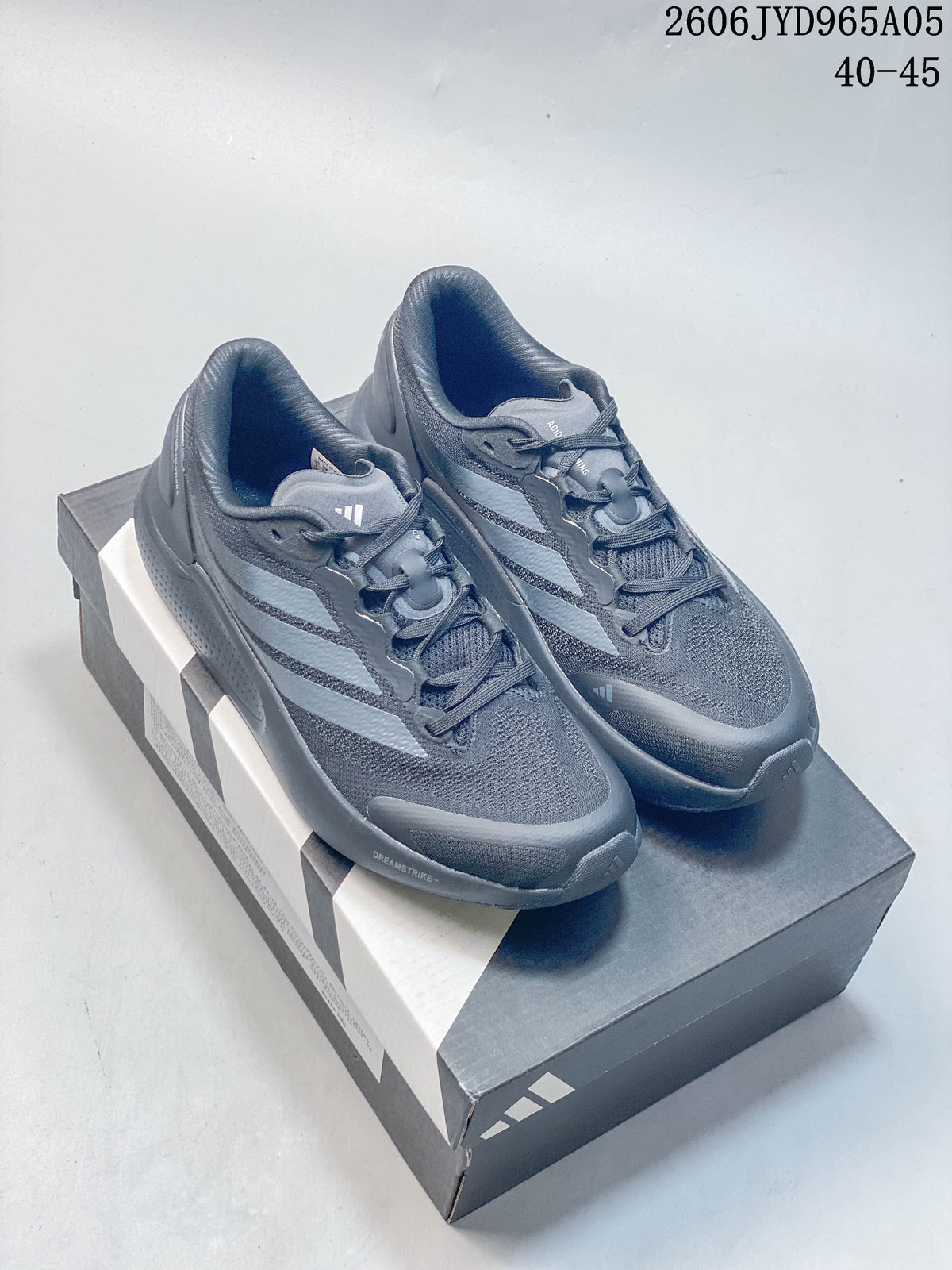 Charcoal Adidas Cushionnova running shoes with light stripes displayed on a shoebox.