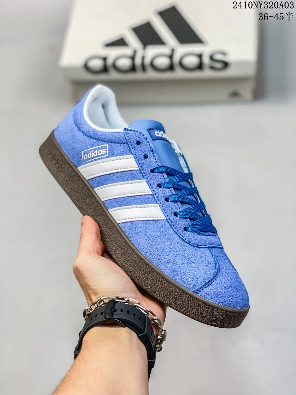 Angled side view of the blue sneaker with white stripes and dark brown outsole