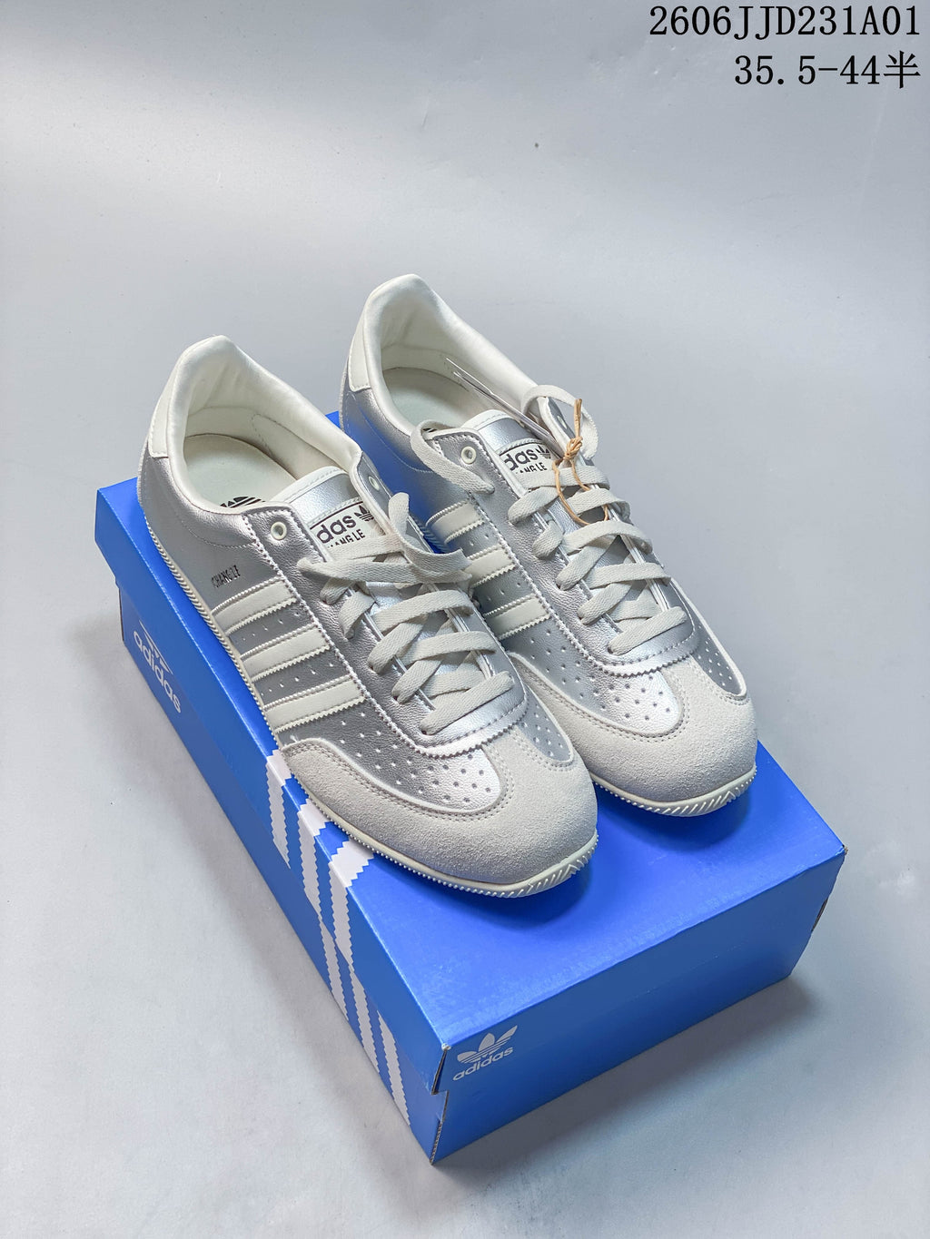 Three Adidas Changle low-top sneakers in navy, silver, and cream, shown from above.