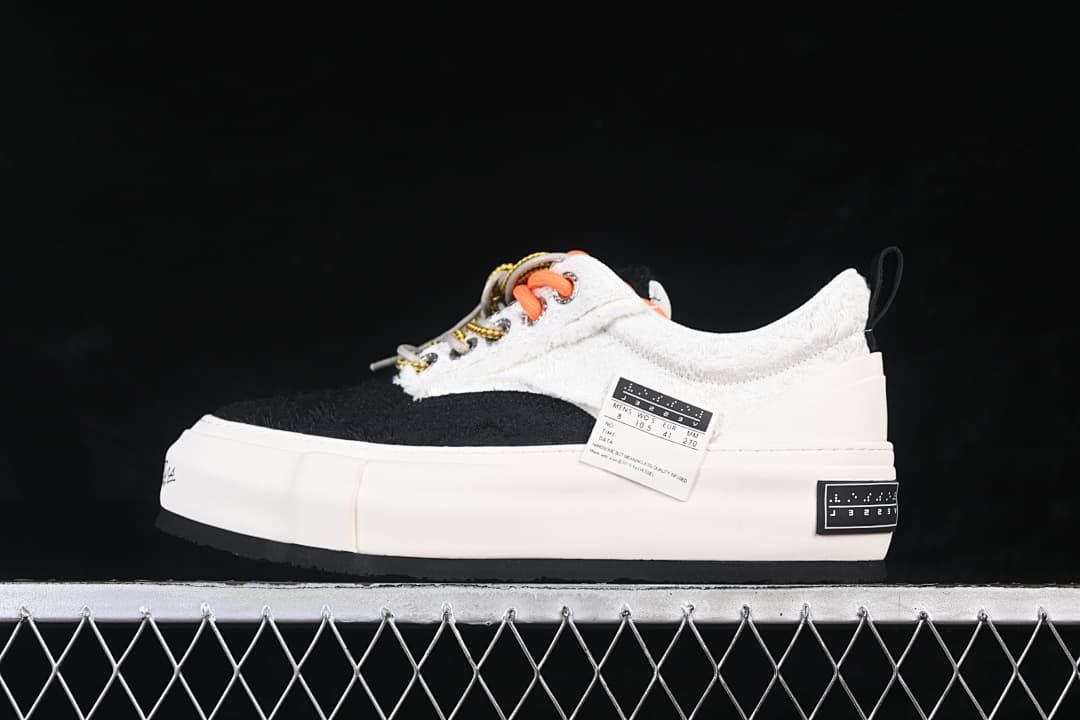 Side view of a white and black VESSEL x Snowflake platform sneaker