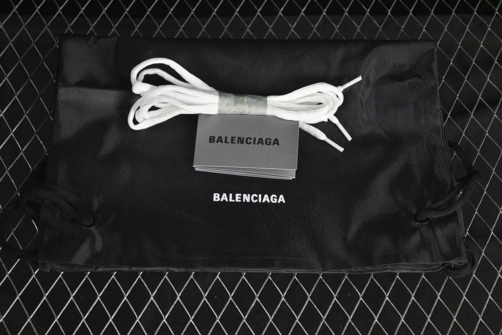 Black drawstring bag and spare white laces shown with the sneakers