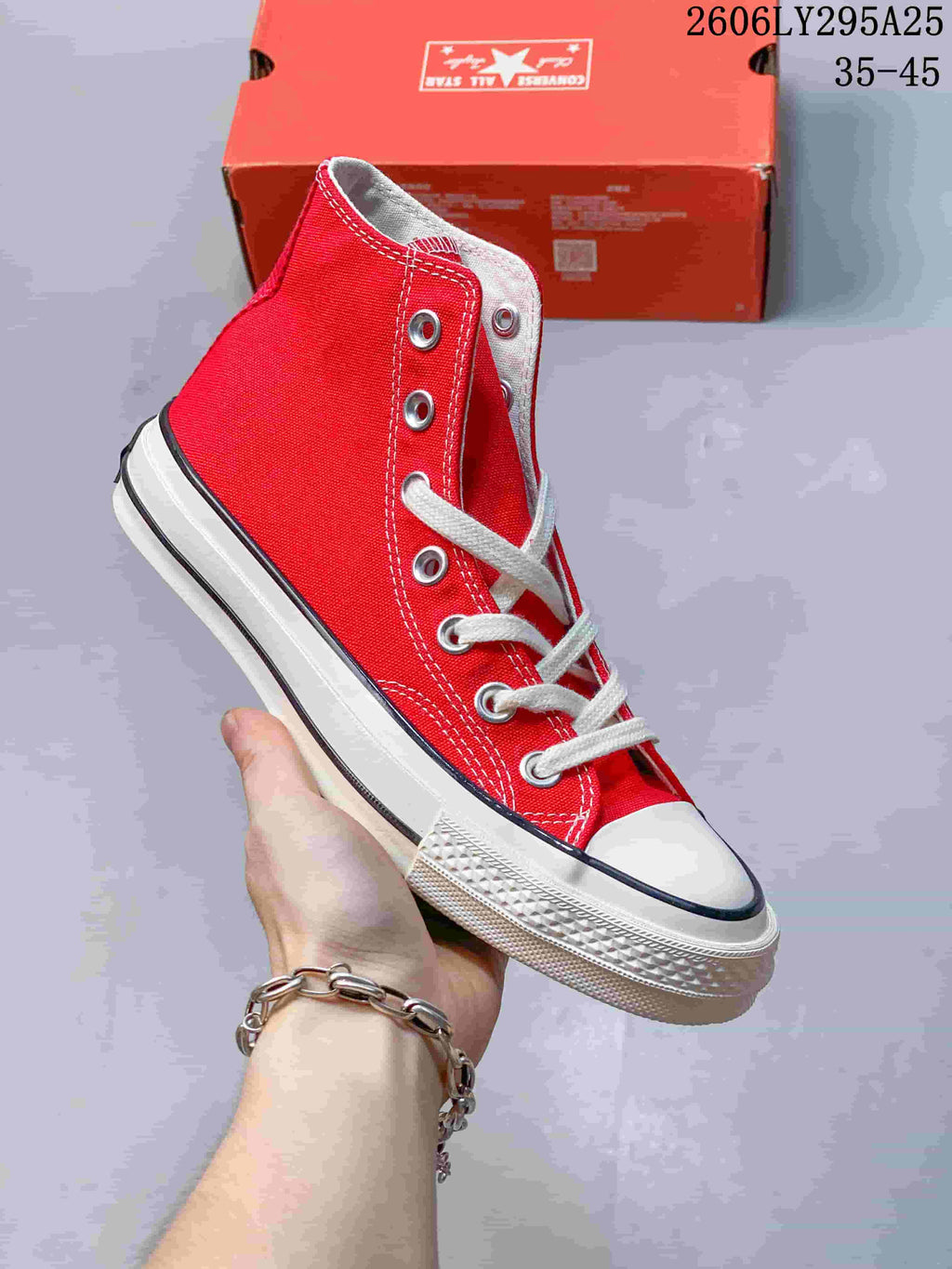 Angled side view of a red Converse high-top sneaker with white laces and a contrast-striped sole