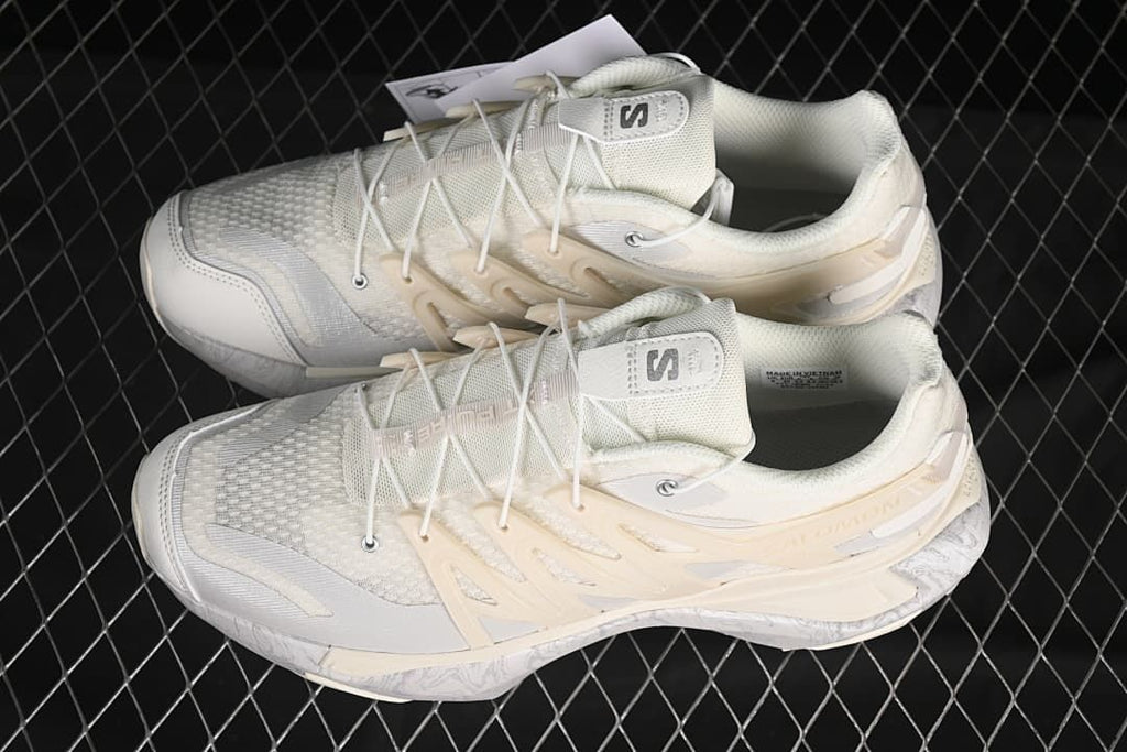 Pair of ivory and gray Salomon XT Pu.re Advanced shoes viewed from above.