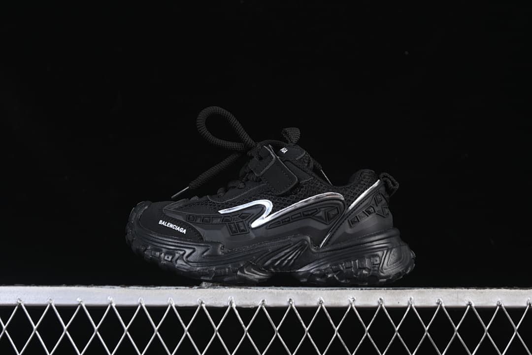 Black children's sneaker shown in side profile with silver-tone accents.