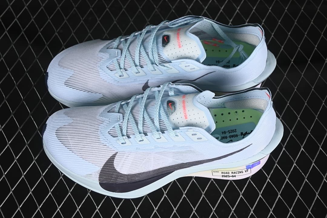 Pair of pale blue and white running shoes shown from above