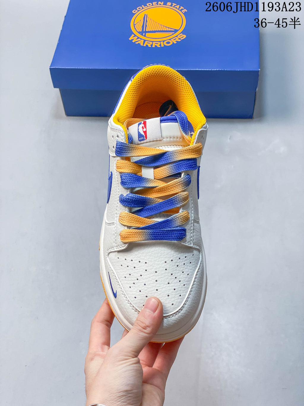 Front view showing perforated toe, blue-and-yellow laces, and yellow collar lining