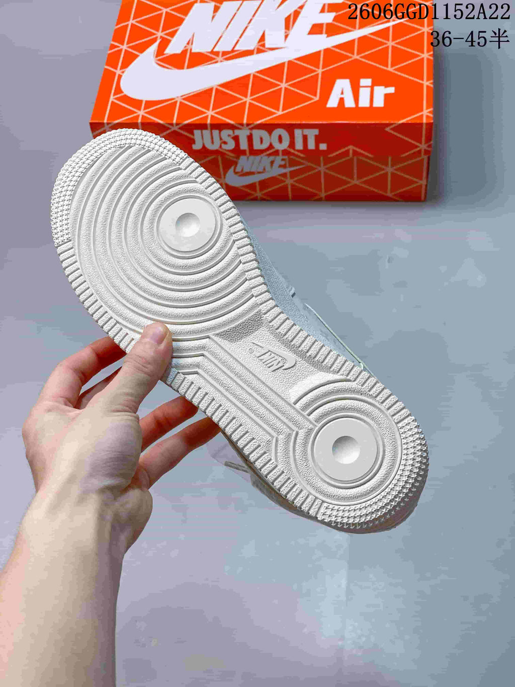 Close-up of the white sneaker outsole showing circular tread details