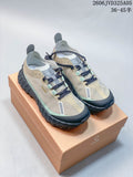 Pair of beige and mint Norda 001 trail running shoes on a branded box.