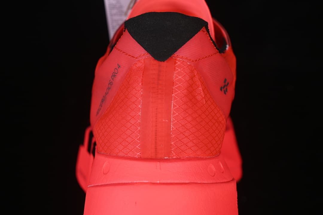Rear view of the coral shoe showing its heel and black collar detail