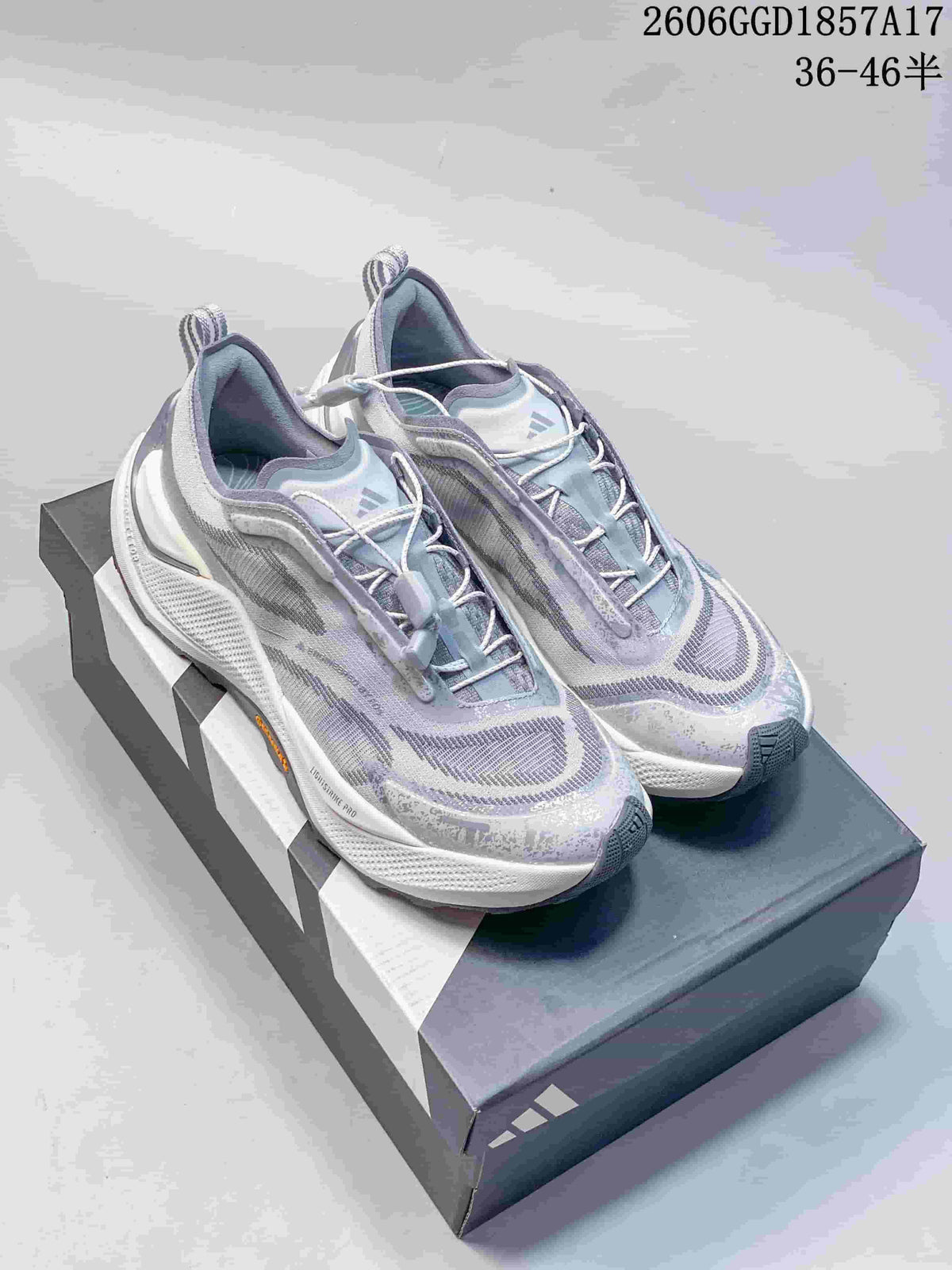Lavender-gray adidas HOLO PEAK trail shoes shown on a shoebox.