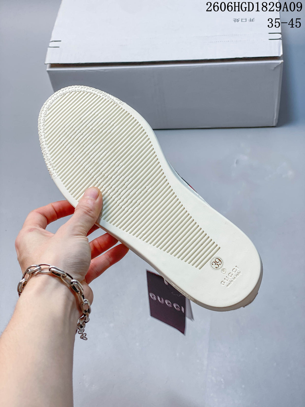 Underside of a sneaker showing a grooved off-white sole and a size 39 marking