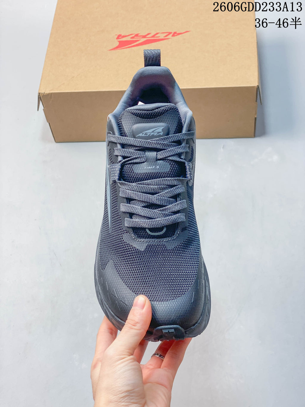 Front view of the shoe showing its laces, mesh-like upper, and tongue branding