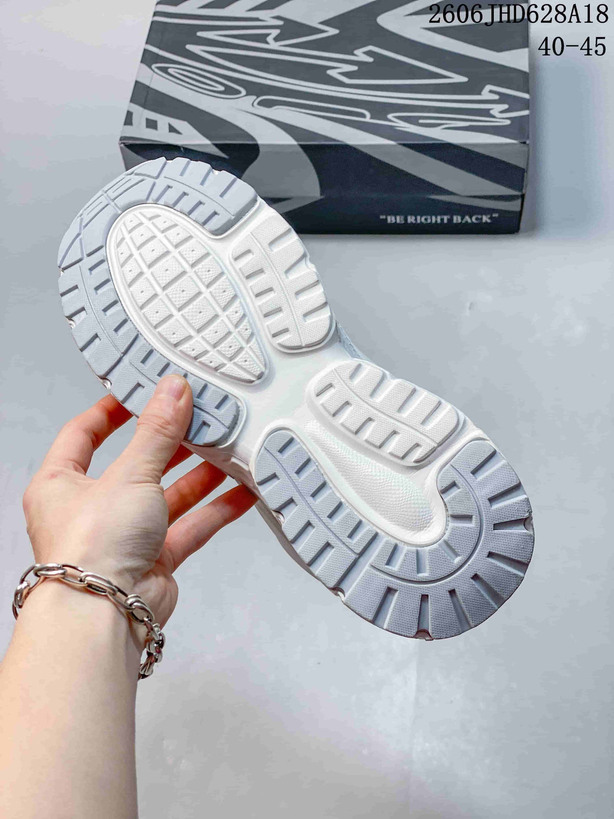 Close-up of the sneaker’s treaded outsole and patterned box
