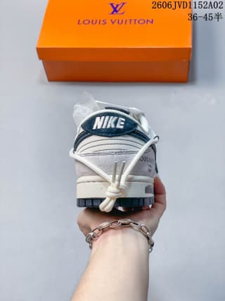 Rear view showing the dark blue heel branding panel, white layered heel construction, and textured outsole edge.