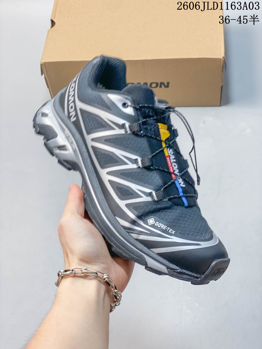 Angled side view of a dark gray Salomon XT-6 GTX sneaker with silver accents