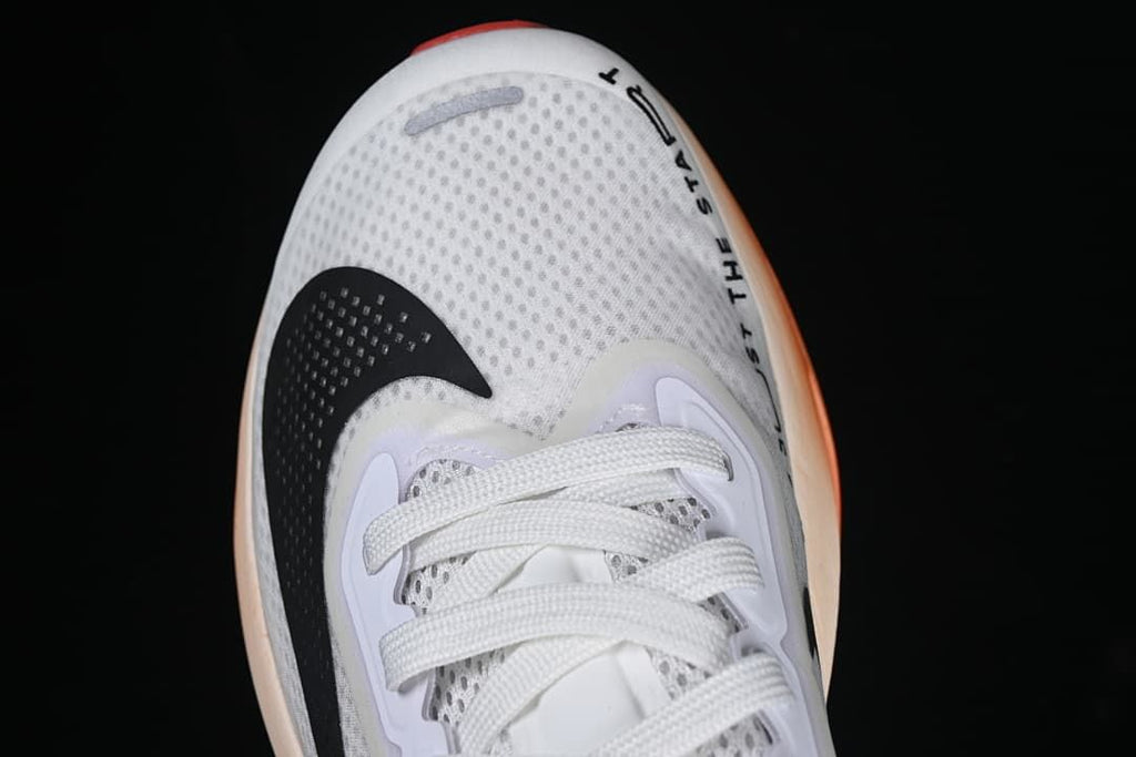 Top view of the shoe's perforated toe, laces and black Swoosh