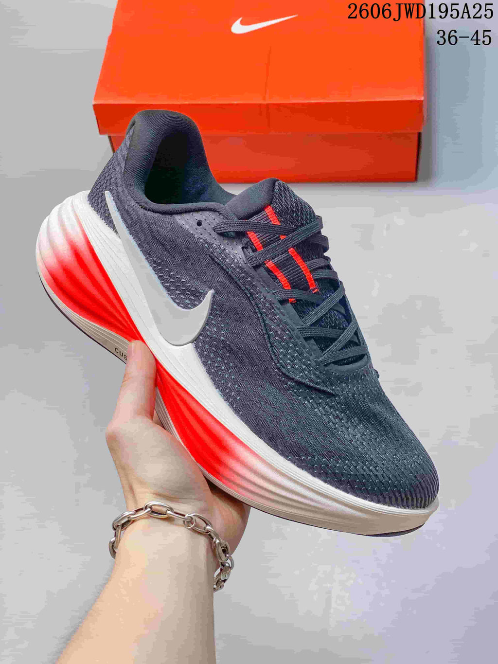 Dark gray running shoe with a white side Swoosh and bright red accents in the midsole.