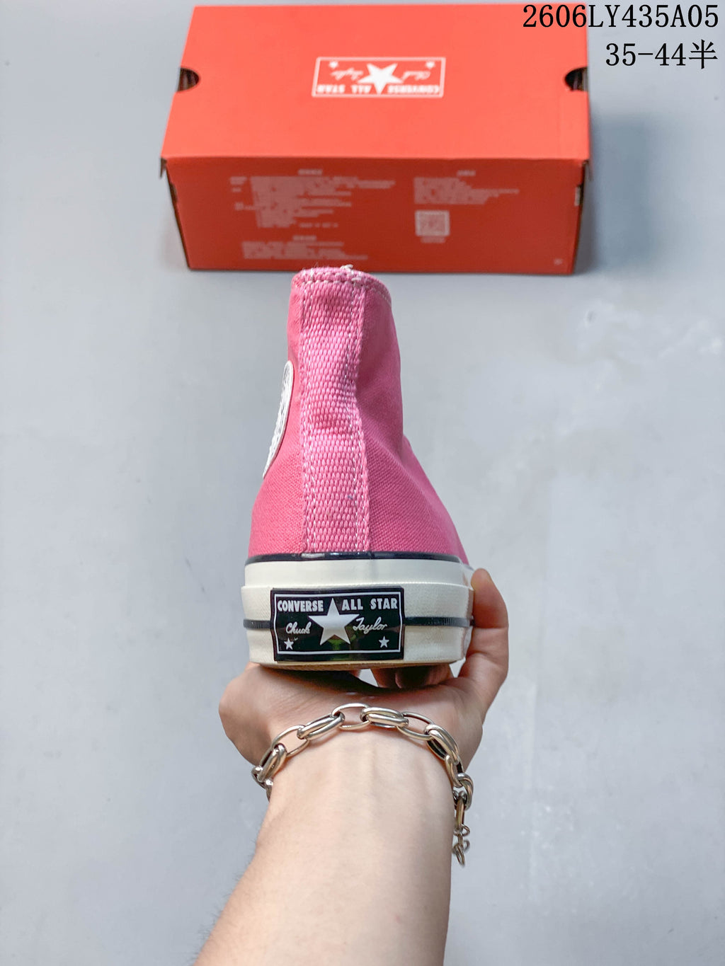 Rear view showing the heel patch on a pink high-top sneaker