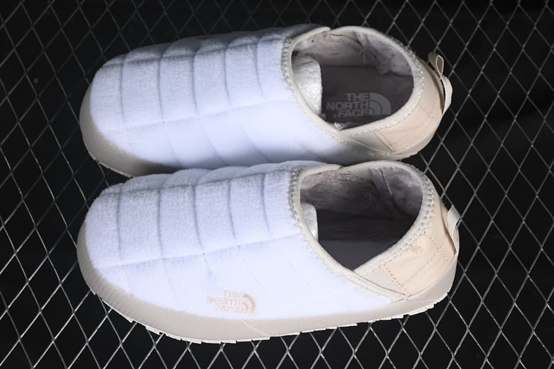 Pair of white and beige mules shown from above