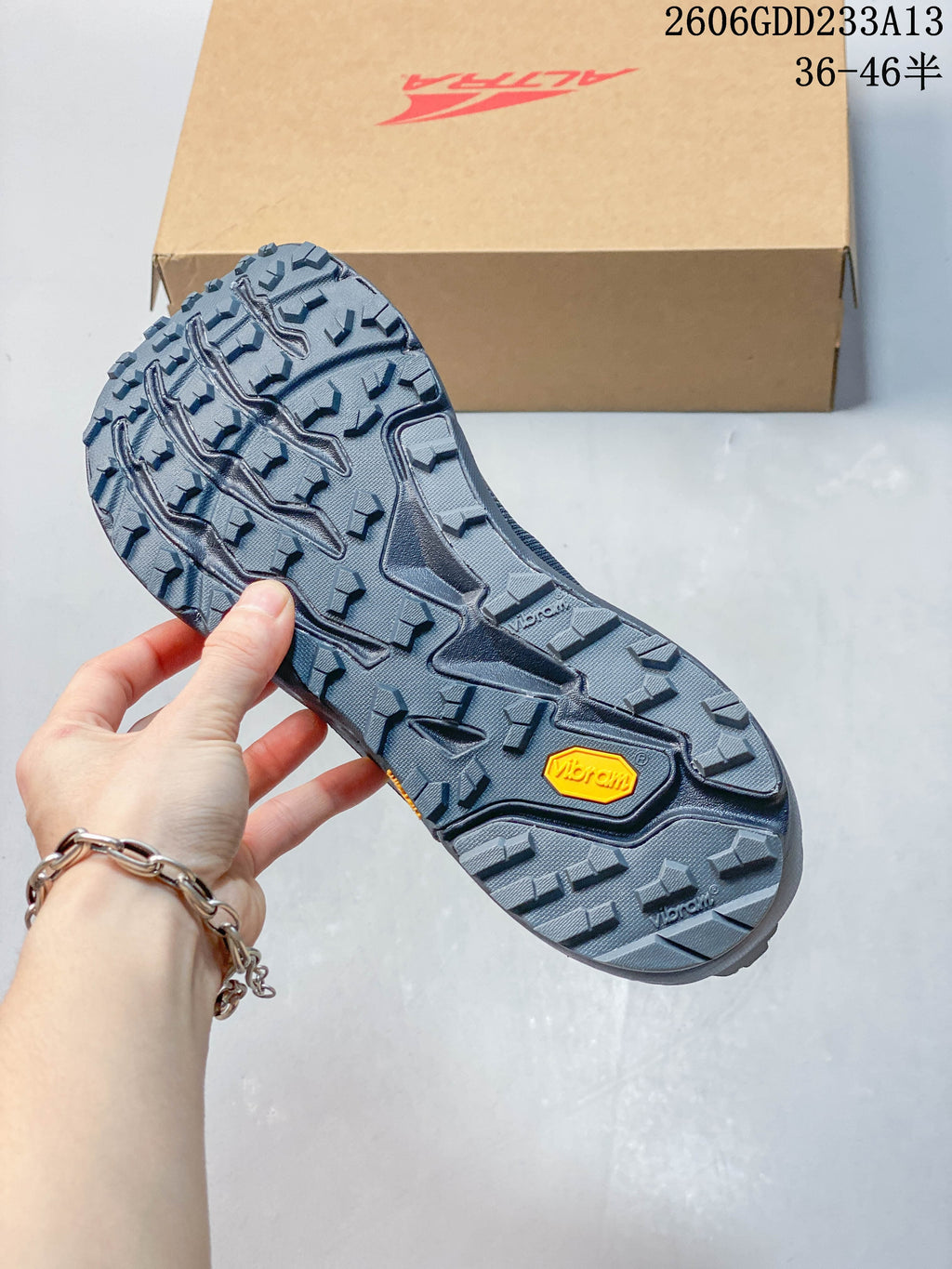 Close-up of the trail shoe outsole with prominent tread and a Vibram mark
