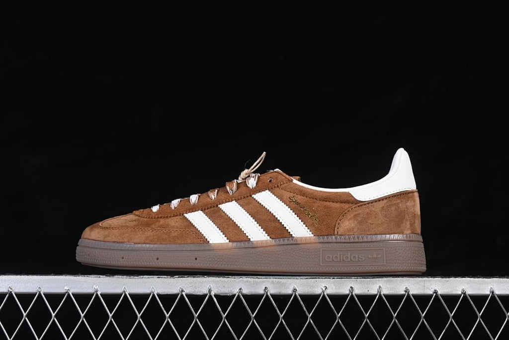 Side profile of brown and white adidas Handball Spezial sneakers with a gum-tone sole
