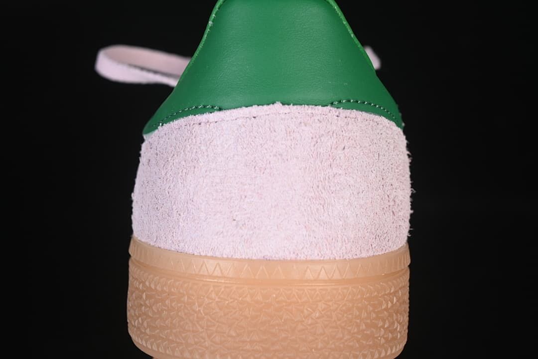 Rear view showing the green heel detail, pink upper and gum sole