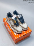 Pair of gray and white low-top sneakers shown on an orange shoebox