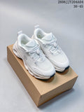 Pair of white On Cloudtilt sneakers with toggle-style lacing on a box