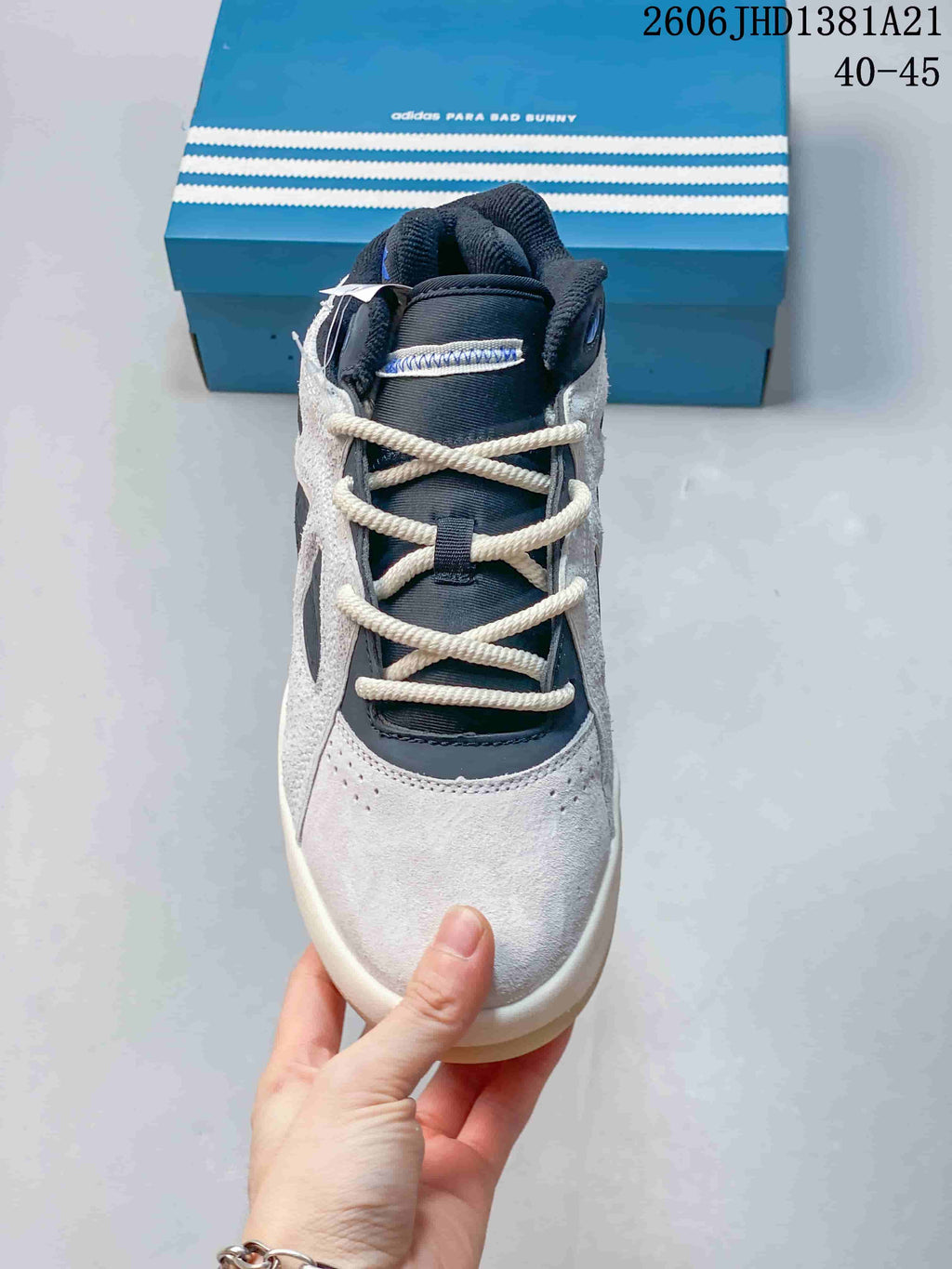 Front view highlighting the laces and panelled upper of the high-top sneaker