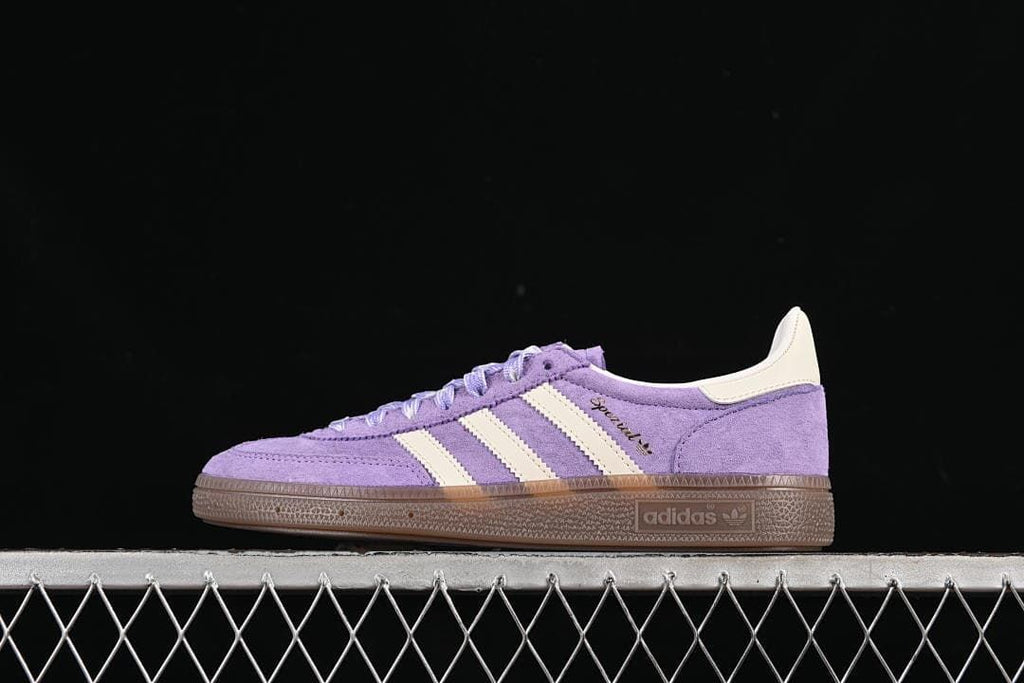 Side view of purple adidas Handball Spezial sneakers with cream stripes and brown sole