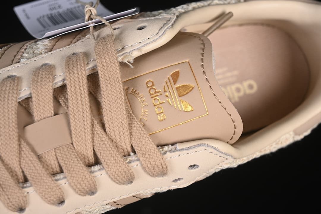 Close-up of the adidas tongue label, beige laces and upper