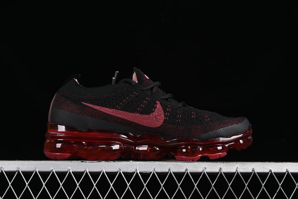 Side profile of the black and dark red sneaker with translucent red sole