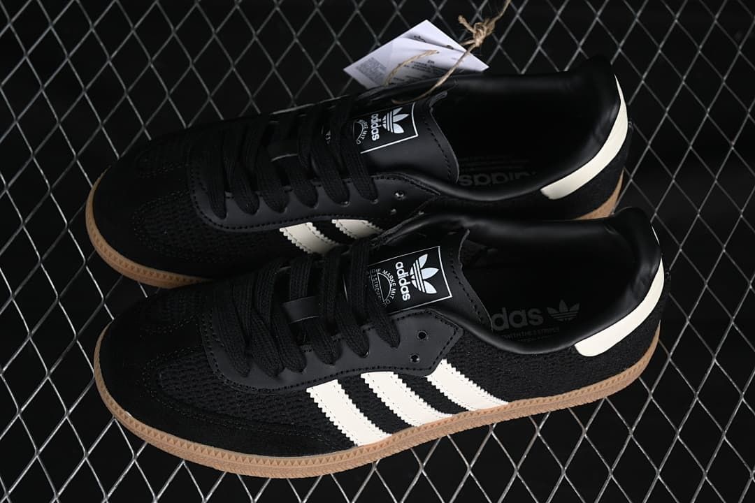 Pair of black adidas Samba OG sneakers with white stripes and gum-colored soles