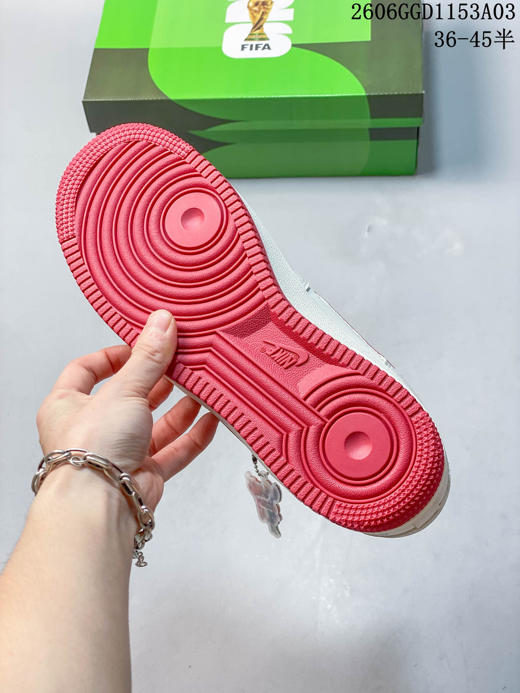 Close-up of the red outsole with circular tread patterns.