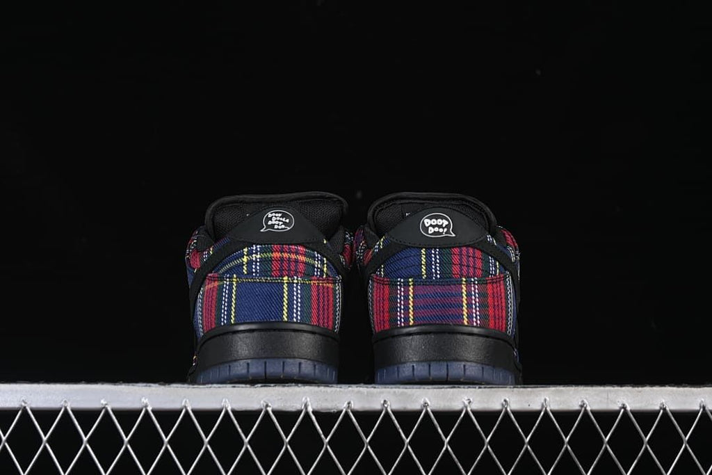 Rear view of both sneakers showing plaid heel panels and heel graphics.
